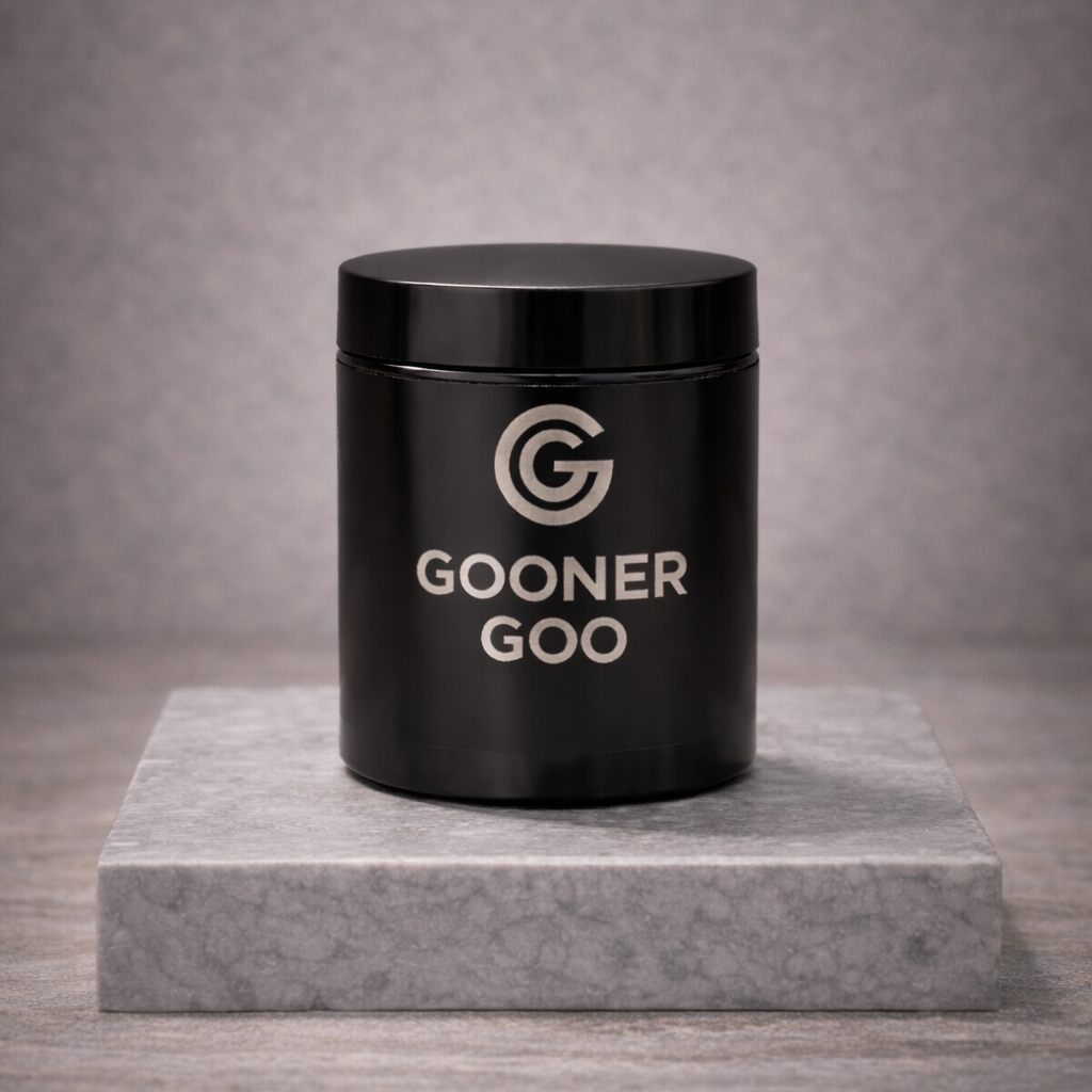 Black container labeled 'GOONER GOO' on a gray marble platform with a gray background